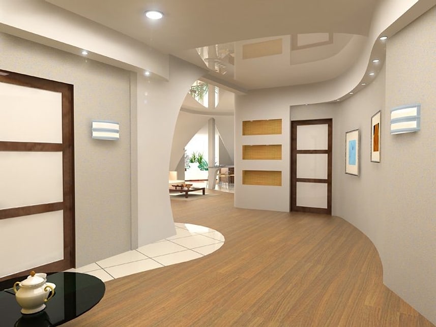 Curved hallway with warm neutral walls and wood flooring